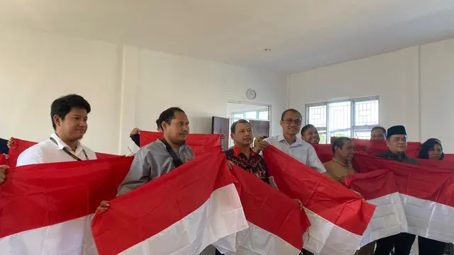 Eks Napiter di Surabaya membagikan sejumlah bendera merah putih. (Dian Kurniawan/Liputan6.com)
