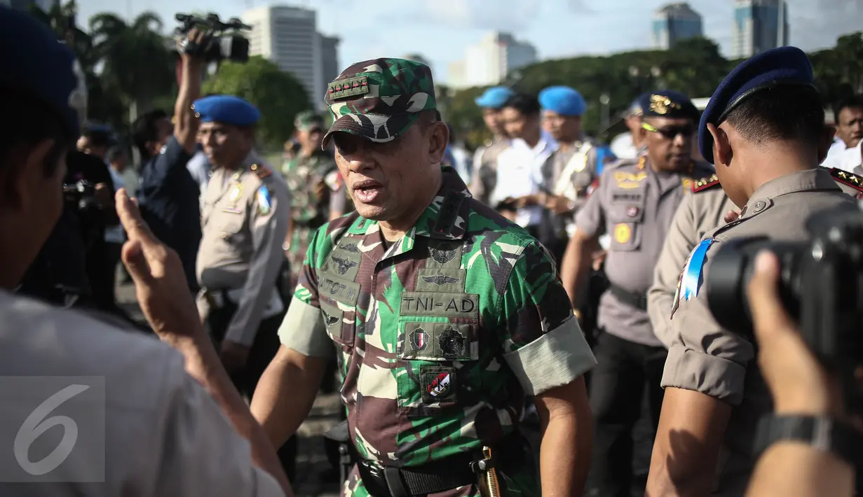 Panglima TNI Jenderal Gatot Nurmantyo menghadiri Apel Gelar Pasukan Operasi Lilin Jaya 2017 di Lapangan Silang Monas, Jakarta, Kamis (22/12). Apel gelar pasukan ini digelar Polri dalam rangka pengamanan Natal dan Tahun 2017. (Liputan6.com/Faizal Fanani)