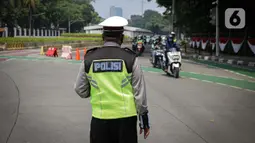Petugas kepolisian mengawasi kendaraan yang melintasi titik pemeriksaan ganjil-genap Bundaran Senayan, Jakarta, Kamis, (26/8/2021). Mulai 26 sampai 30 Agustus, ganjil genap hanya berlaku di 3 ruas jalan Jakarta yakni, Jalan Sudirman, MH Thamrin, dan HR Rasuna Said. (Liputan6.com/Faizal Fanani)