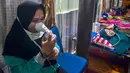 Warga yang terpapar kabut asap karhutla menghirup oksigen ketika berada di Rumah Singgah Korban Asap di Pekanbaru, Riau, Jumat (20/9/2019). Data Kemenkes sebanyak 15.346 warga di Provinsi Riau menderita ISPA akibat kabut asap karhutla dalam kurun waktu September 2019. (Wahyudi/AFP)