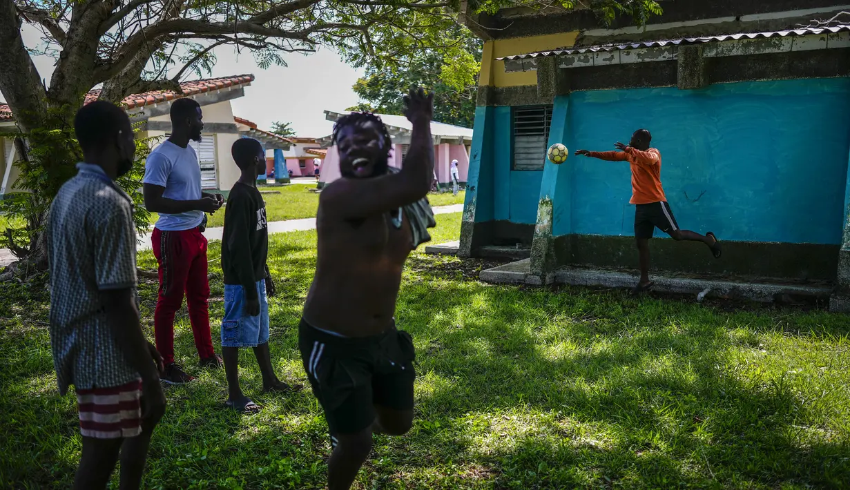 Seorang imigran Haiti merayakan golnya selama pertandingan di sebuah perkemahan yang digunakan untuk menampung sekelompok besar migran Haiti di Sierra Morena di provinsi Villa Clara Kuba, Kamis (26/5/2022). 800 warga Haiti yang berusaha mencapai Amerika Serikat malah berakhir di pantai Kuba tengah. (AP Photo/Ramon Espinosa)