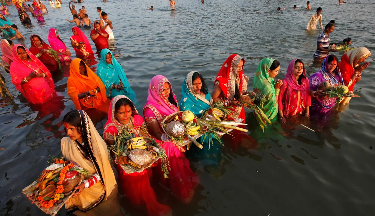 Sejumlah umat Hindu melakukan ritual menyembah dewa Matahari selama festival keagamaan Chhat Puja di Chandigarh, India (6/11). Ritual ini  merupakan bentuk terima kasih mereka kepada Dewa Matahari yang telah memberikan kehidupan. (Reuters/Ajay Verma)