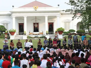 Presiden Jokowi dan Ibu Iriana, bermain bersama anak-anak dari beberapa sekolah di halaman belakang Istana Merdeka, Jakarta, Jumat (20/7). Kegiatan tersebut dalam rangka mengumumkan dan menampilkan lomba cipta lagu anak. (Liputan6.com/Angga Yuniar)