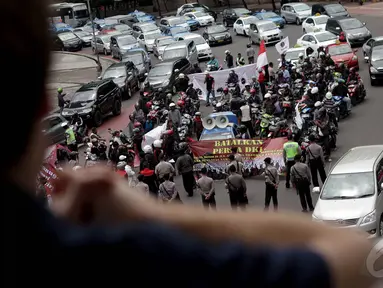 Massa dari Front Transportasi Jakarta (FrontJak) melakukan aksi unjuk rasa di Bundaran HI, Jakarta, Kamis (8/1/2015). (Liputan6.com/Faizal Fanani)