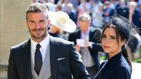 Senyum mantan pemain sepak bola Inggris, David Beckham dan sang istri Victoria Beckham saat menghadiri pernikahan Pangeran Harry dan Meghan Markle di St. George's Chapel, Kastil Windsor, Inggris, Sabtu (19/5). (IAN WEST/POOL/AFP)