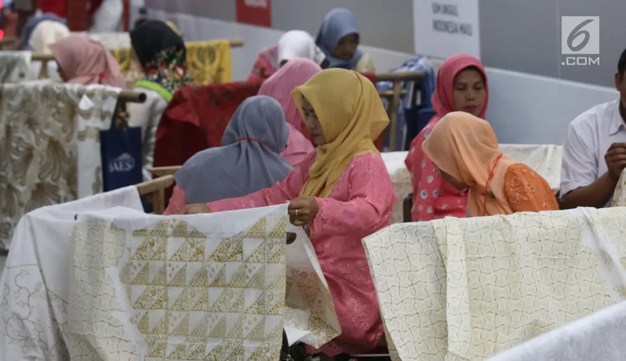 Pengrajin tengah membatik di Stasiun MRT Bundaran HI, Jakarta, Kamis (1/8/2019). Pada acara batik kemerdekaan tersebut para pengrajin membatik pada kain sepanjang 74 meter. Angka 74 disesuaikan dengan usia Republik Indonesia yang akan dirayakan 17 Agustus mendatang. (Liputan6.com/Angga Yuniar)