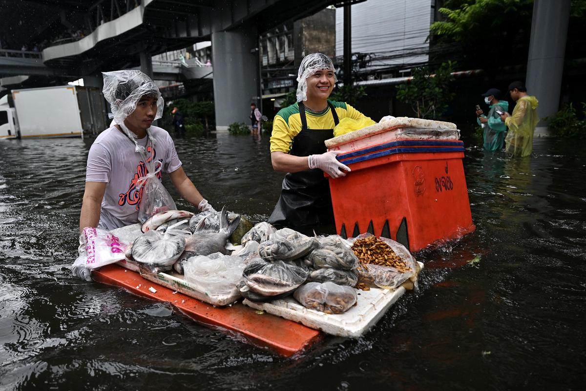 Banjir Parah Rendam Bangkok Warga Berjualan di Tengah Genangan