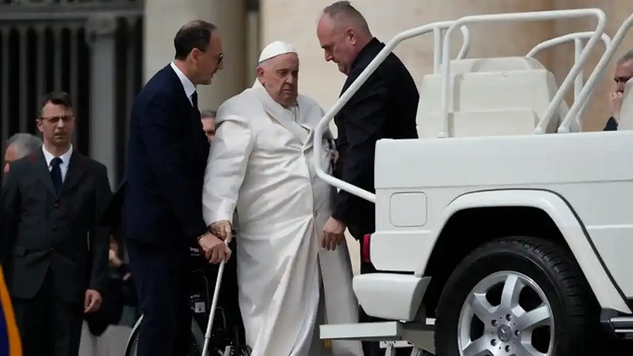 Paus Fransiskus saat dibawa masuk ke mobilnya di Lapangan Santo Petrus pada Rabu (29/3/2023), untuk dibawa ke rumah sakit. (Dok. Alessandra Tarantino/AP)