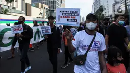 Warga dari Komunitas Peduli Sampah membawa poster aksi saat Hari Bebas Kendaraan Bermotor di Bundaran HI, Jakarta, Minggu (26/6/2022). Kampanye tentang sampah tersebut dalam rangka melanjutkan Pekan Gerakan Jakarta Sadar Sampah yang menghimbau masyarakat untuk saling menjaga kebersihan lingkungan. (Liputan6.com/Johan Tallo)