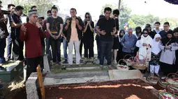 Musisi Indra Lesmana bersama keluarga dan kerabat berdoa saat pemakaman ibunya, Nien Lesmana di TPU Tanah Kusir, Jakarta, Rabu (28/6). Ibu dari Indra Lesmana dan Mira Lesmana meninggal dunia pada usai 88 tahun. (Liputan6.com/Herman Zakharia)