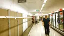 Rak-rak kosong tempat tisu toilet di sebuah supermarket di Sydney, Rabu (4/3/2020). Supermarket terbesar Australia mengumumkan batas pembelian tisu toilet dan pembersih tangan (handsanitizer) setelah terjadinya panic buying akibat ketakutan penyebaran virus corona COVID-19. (PETER PARKS/AFP)
