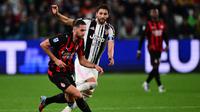 Gelandang AC Milan, Adrien Rabiot, berjibaku melawan gelandang Juventus, Manuel Locatelli, pada pertandingan Liga Italia 2025/2026 di The Allianz Stadium, Turin, Senin (6/10/2025) dini hari WIB. (AFP/Marco Bertorello)