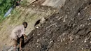 Pencari besi bekas mulai mencari buruannya di tumpukan lumpur sisa pengerukan Kali Ciliwung, Jakarta, Jumat (29/7). Meski terhalang dengan adanya alat berat, tak membuat ia berhenti mencari besi bekas. (Liputan6.com/Yoppy Renato)