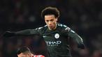 Gelandang Manchester City Leroy Sane berebut bola dengan pemain Arsenal, Granit Xhaka pada laga pekan ke-28 Premier League di Emirates Stadium,  Jumat (2/3). Tampil di kandang lawan, Manchester City melibas Arsenal dengan skor 3-0. (Glyn KIRK/AFP)