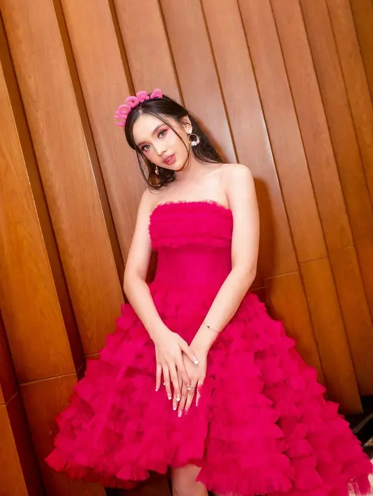 Strapless dress dengan rok bervolume asimetris itu bikin Lyodra terlihat feminin [@lyodraofficial]