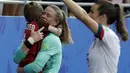United States goalkeeper Alyssa Naeher holds a young boy as they celebrates at the end of the Women's World Cup round of 16 soccer match between Spain and US at the Stade Auguste-Delaune in Reims, France, Monday, June 24, 2019. US beat Spain 2-1. (AP Photo/Alessandra Tarantino)
