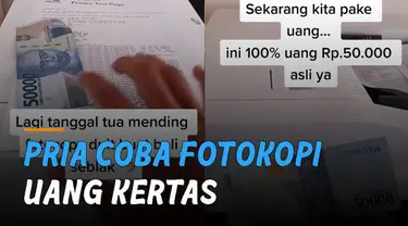 Seorang pria mencoba memfotokopi selembar uang kertas menggunakan mesin fotokopi.