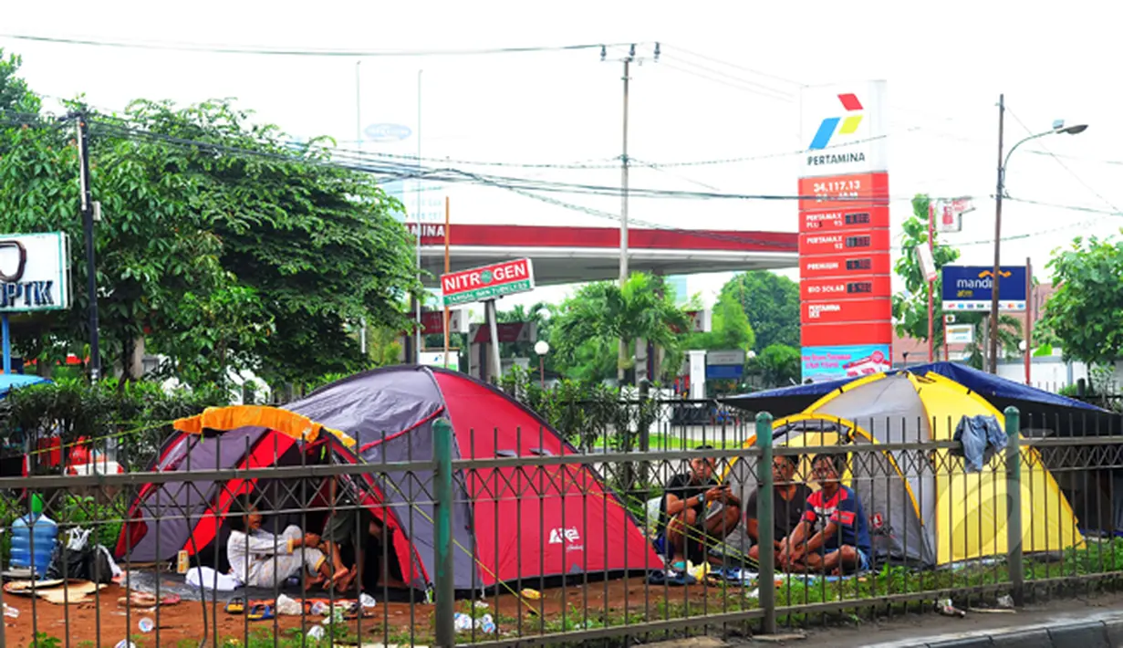 Sejumlah warga korban banjir mengungsi di bawah kolong Jembatan Pesing, Grogol, Jakarta, Rabu (11/2/2015). Para pengungsi harus rela tinggal di tenda darurat karena rumah mereka terendam banjir. (Liputan6.com/Faisal R Syam)