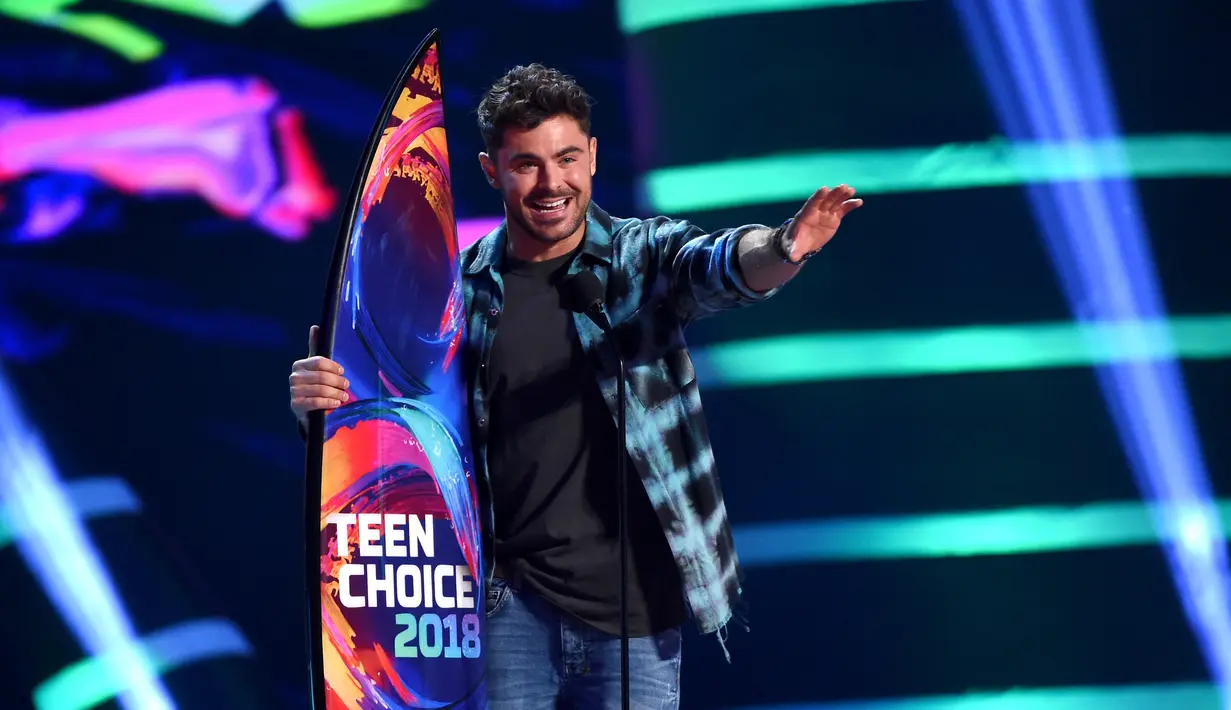 Aktor Zac Efron menerima penghargaan untuk kategori Film Terbaik dalam The Greatest Showman pada Teen Choice Awards di California, 12 Agustus 2018. Zac mewakili kru THE GREATEST SHOWMAN mengambil piala ke atas panggung. (Kevin Winter/Getty Images/AFP)