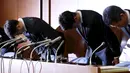 Pebulutangkis Jepang, Kento Momota (kedua kanan) and Kenichi Tago (kiri) membungkuk sebagai bentuk penyesalan saat mengakui telah bermain judi di sebuah kasino ilegal dalam konferensi pers yang digelar di Tokyo, Jumat (8/4). (REUTERS/Issei Kato)