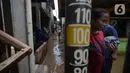 Warga membersihkan lumpur sisa banjir di Kelurahan Rawa Jati, Jakarta, Selasa (9/2/2021). Endapan lumpur yang mengendap akibat luapan Kali Ciliwung. (merdeka.com/Imam Buhori)