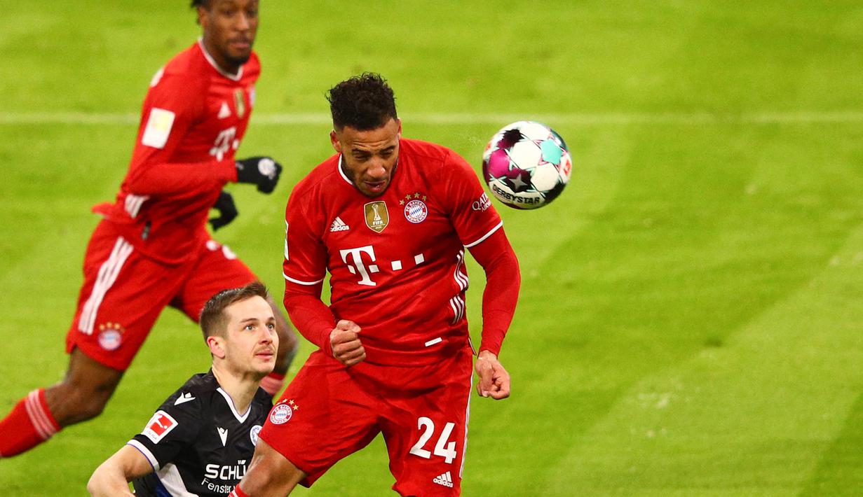 Gelandang Bayern Munich, Corentin Tolisso (kanan) melepaskan sundulan yang berbuah gol kedua timnya ke gawang Arminia Bielefeld dalam laga lanjutan Liga Jerman 2020/21 pekan ke-21 di Allianz Arena, Munich, Senin (15/2/2021). Bayern bermain imbang 3-3 dengan Bielefeld. (AFP/Adam Pretty/Pool)