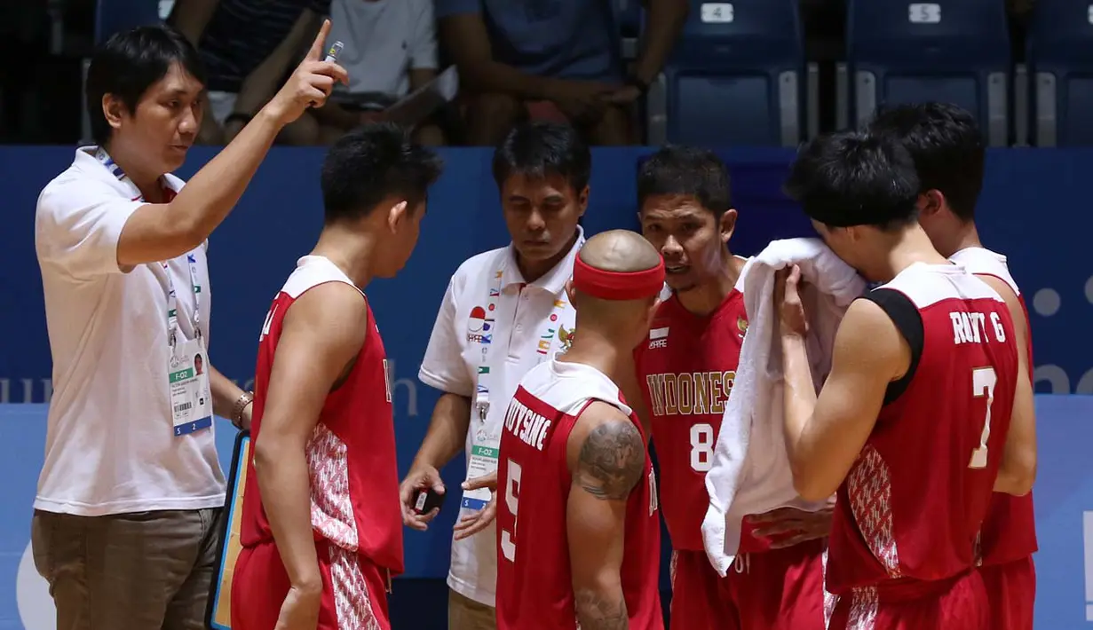 Pelatih basket putra Indonesia, Fictor Gideon Roring (kiri), terus memompa semangat pemain-pemainnya. (Bola.com/Arief Bagus)
