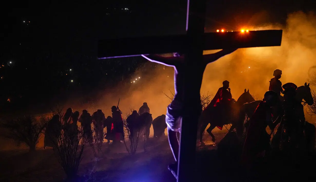 Umat Kristen mengambil bagian dalam peragaan ulang Via Crucis atau Jalan Salib saat peringatan Jumat Agung di Colina, Chile, 15 April 2022. Orang-orang Kristen di seluruh dunia menghadiri penyaliban tiruan dan drama gairah yang menandai hari Yesus disalibkan. (AP Photo/Esteban Felix)