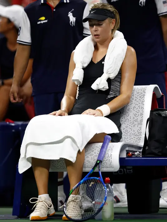 Maria Sharapova dari Rusia beristirahat saat bertanding melawan Patty Schnyder yang berusia 39 tahun asal Swiss selama putaran pertama tunggal putri turnamen tenis AS Terbuka 2018 di New York, (28/8). (AFP Photo/Julian Finney)