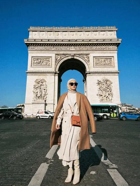 <p>Outfit layering untuk liburan musim dingin tetap bisa membuatmu stylish. Seperti Dinda Hauw yang menggunakan coat sebagai luaran dengan kombinasi warna serasi. [Instagram/dindahw]</p>