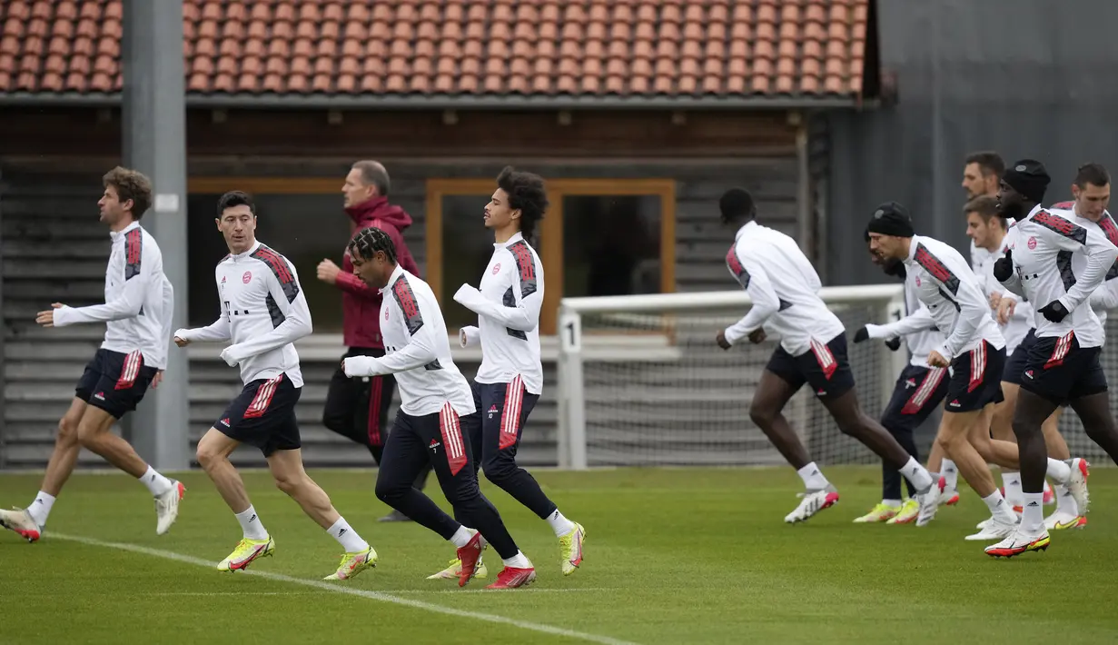 Penyerang Bayern Munchen, Robert Lewandowski (kedua kiri) menyaksikan timnya melakukan pemanasan selama sesi latihan di Munich, Jerman, Senin (1/11/2021). Bayern Munchen akan meladeni Benfica pada matchday 4 Grup E Liga Champions 2021/22, Rabu (3/11) dini hari WIB. (AP Photo/Matthias Schrader)