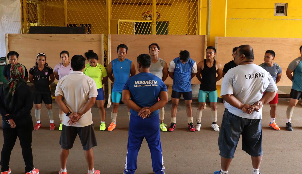 Atlet Angkat Besi Indonesia sedang bersiap untuk berlatih dekat halaman Parkir Angkat Besi di Senayan, Jakarta, Senin (11/1/2016). Hal ini karena tempat Latihan dalam tahap renovasi. (Bola.com/Nicklas Hanoatubun)