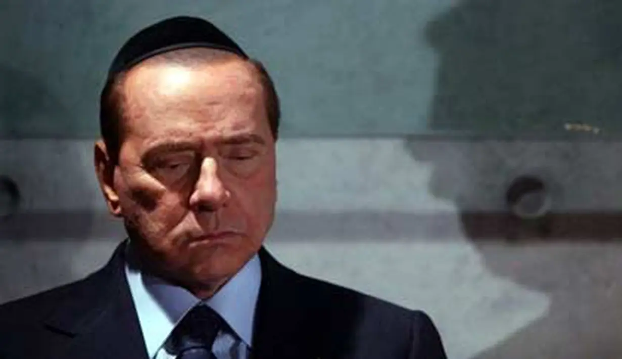 Italian Prime Minister Silvio Berlusconi stands outside the Children&#039;s Memorial of the Yad Vashem Holocaust Memorial where a plaque honors children killed in the Auschwitz Nazi camp, on 01 February 2010 in Jerusalem. AFP PHOTO/JIM HOLLANDER 