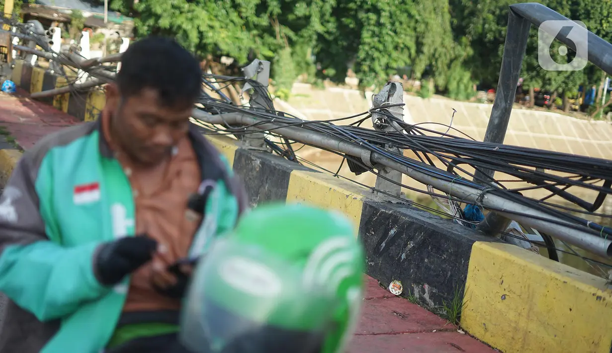 Kondisi pagar jembatan yang rusak di kawasan Bukit Duri, Jakarta, Jumat (21/2/2020). Pagar yang rusak akibat penanganan sampah banjir tersebut hingga kini belum juga diperbaiki. (Liputan6.com/Immanuel Antonius)