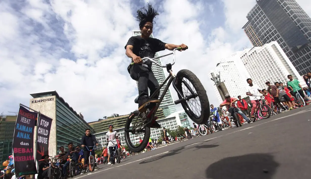 Sejumlah penggemar sepeda BMX memanfaatkan hari car free day dengan melakukan atraksi freestyle, Jakarta, Minggu (14/12/2014) (Liputan6.com/Faizal Fanani)