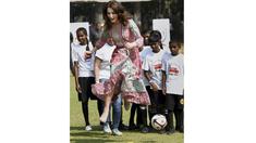 Istri Pangeran William, Catherine Middleton bermain bola bersama anak-anak di Mumbai, India, Minggu (10/4/2016). (Reuters/Mitesh Bhuvad/Pool)