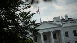 Pemandangan bendera nasional AS yang berkibar setengah tiang di Gedung Putih, Washington DC, Minggu (4/8/2019). Presiden Donald Trump memerintahkan bendera dikibarkan setengah tiang selama lima hari sebagai simbol dukacita atas dua penembakan massal di El Paso, Texas, dan Ohio. (Eric BARADAT/AFP)