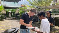 Seorang suporter Timnas Indonesia Kadek Martha Saputra saat meminta tanda tangan Ole Romeny di Lapangan Mini Soccer Bali Sepak Bumi pada Jumat (23/5/2025). (Bola.com/Alit Binawan)