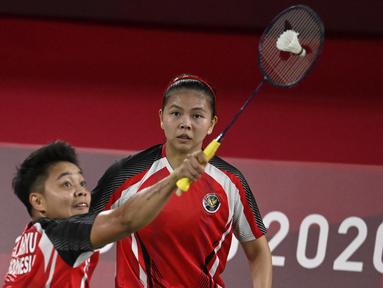 Pasangan ganda putri Indonesia, Greysia Polii/Apriyani Rahayu mengawali langkahnya di Olimpiade Tokyo 2020 dengan kemenangan dua gim langsung atas pasangan Malaysia, Chow Mei Kuan/Lee Men Yean, 21-14 dan 21-17 di babak penyisihan Grup A nomor ganda putri. (Foto: AFP/Alexander Nemenov)