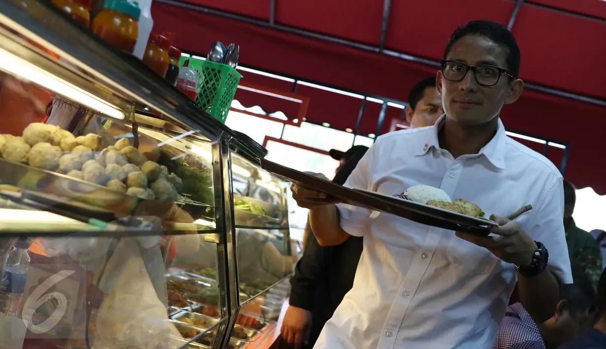 Cawagub DKI Jakarta, Sandiaga Uno membeli makan siang disela kampanyenya di ITC Mangga Dua, Jakarta Utara, Kamis (3/11). Di ITC tersebut, Sandiaga menyempatkan diri mendengar keluh kesah para pedagang. (Liputan6.com/Gempur M Surya)