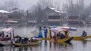 Turis berfoto sambil berdiri di atas gondola tradisional di Danau Dal di Srinagar, Kashmir yang dikuasai India pada 25 Februari 2022. Perlahan tapi pasti, kehidupan di Asia Selatan kembali normal dan orang-orang berharap yang terburuk dari pandemi COVID-19 ada di belakang mereka (AP Photo/Dar Yasin)