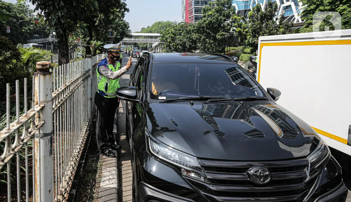 Polisi lalu lintas berkomunikasi dengan pengendara mobil saat Operasi Zebra Jaya 2022 di Jakarta, Selasa (4/10/2022). Operasi Zebra Jaya dilaksanakan pada tanggal 3 hingga 17 Oktober untuk menekan jumlah pelanggaran lalu lintas. (Liputan6.com/Faizal Fanani)