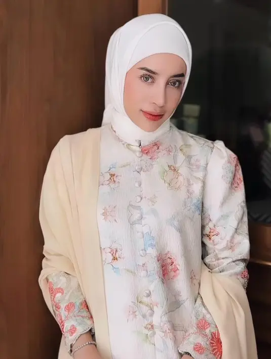 Baju kurung motif floral buat looks Aghnia semakin anggun.Ia melengkapi penampilannya dengan hijab segi empat warna senada dengan baju kurungnya. [@emyaghnia]