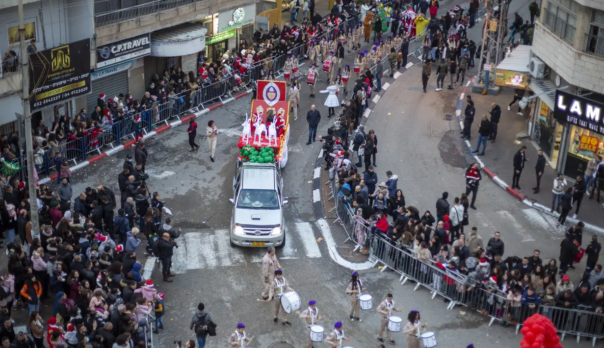 Umat Kristen Arab Israel merayakan parade Natal tahunan di Nazareth, Israel, Jumat (24/12/2021). (AP Photo/Ariel Schalit)