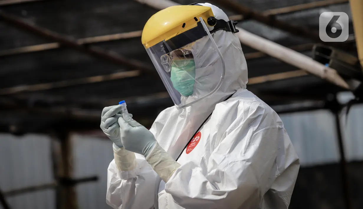Petugas medis membawa sampel saat menggelar swab test COVID-19 di Pasar Tasik, Jakarta, Kamis (2/7/2020). Tes yang dilakukan secara acak bagi pedagang itu bertujuan untuk mendeteksi serta mencegah penyebaran COVID-19 di kawasan Pasar Tasik. (Liputan6.com/Faizal Fanani)