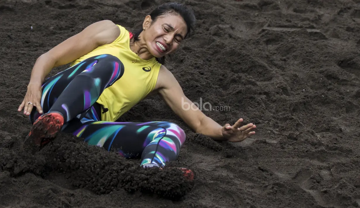 Atlet atletik Indonesia, Maria Londa, melakukan pendaratan saat latihan jelang SEA Games 2017 di Lapangan umum Mengwi, Bali, Minggu (10/7/2017). (Bola.com/Vitalis Yogi Trisna)