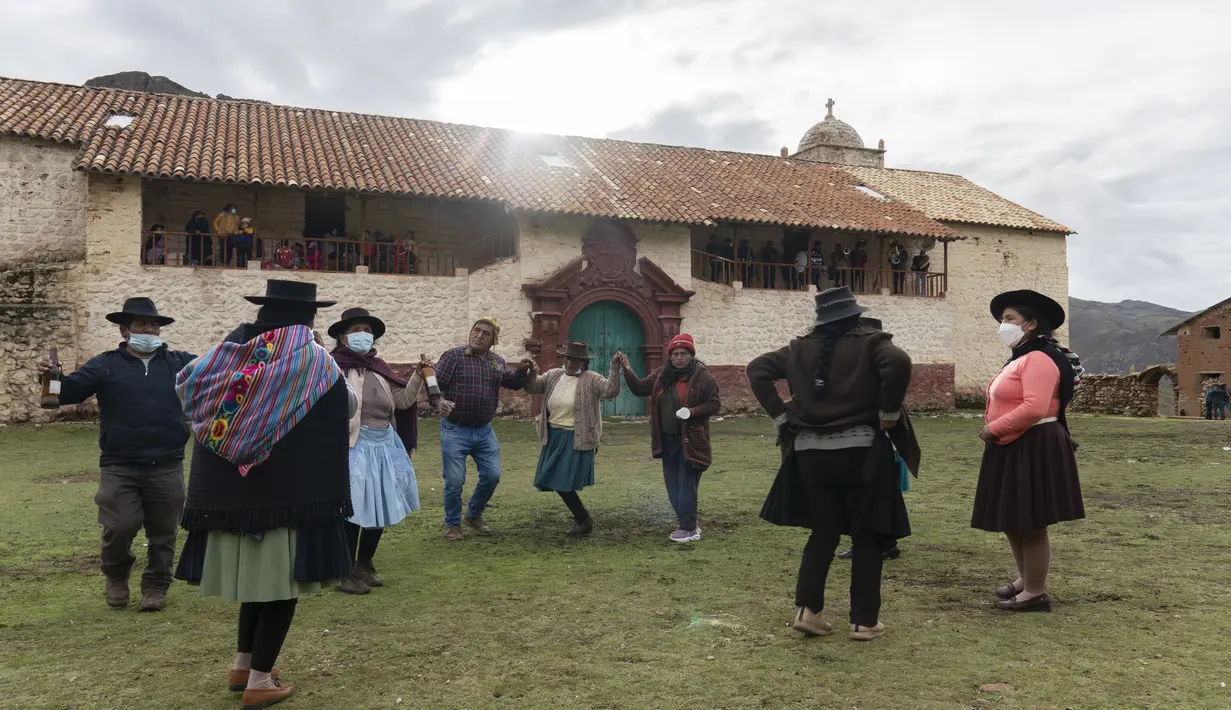 Pria dan wanita menari di alun-alun kota hantu Santa Barbara, Peru, Sabtu (4/12/2021). Pada masa penjajahan Spanyol, Santa Barbara pernah menjadi tambang merkuri terbesar di Amerika. (AP Photo/Franklin Briceño)