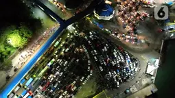 Foto udara kendaraan pribadi pemudik mengantre untuk memasuki kapal "Roll on-Roll off" (RoRo) di Pelabuhan Merak, Banten, Kamis (28/4/2022). Pelabuhan Merak terpantau ramai pemudik pada puncak arus mudik H-3 Idul Fitri atau Lebaran 2022. Peningkatan pemudik dan kendaraan di pelabuhan tersebut menyebabkan kemacetan. (Liputan6.com/Angga Yuniar)