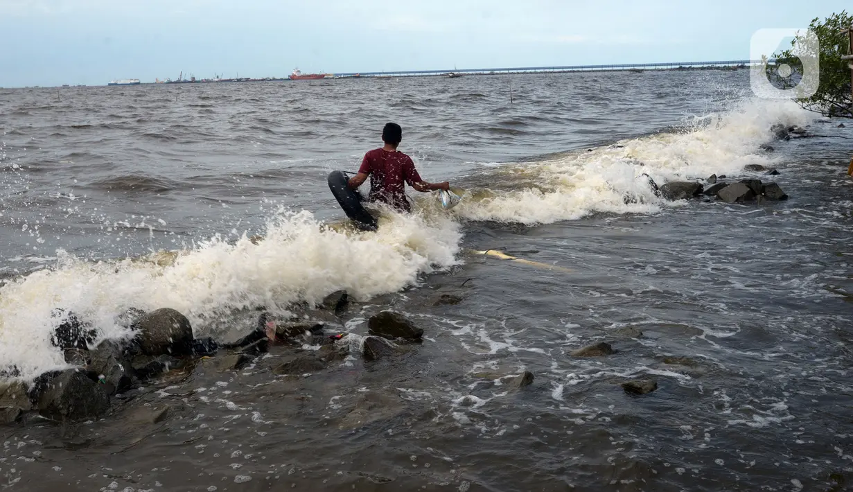 Aktivitas warga di pantai Marunda dan kawasan Si Pitung, Jakarta, Kamis (9/12/2021). Di beberapa titik masih tergenang akibat banjir rob (air laut pasang) dan gelombang  pasang air laut merupakan masalah serius yang dihadapi beberapa wilayah pesisir di Indonesia. (merdeka.com/Imam Buhori)