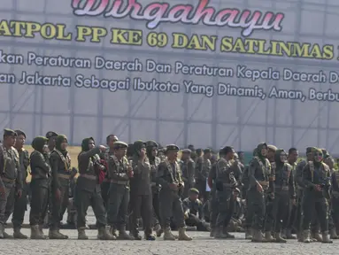 Satuan Polisi Pamong Praja (Satpol PP) mengikuti upacara peringatan HUT ke-69 Satpol PP dan ke-57 Satuan Perlindungan Masyarakat (Satlinmas) di Lapangan Monas, Jakarta, Rabu (7/8/2019). Dalam peringatan itu, Gubernur DKI Anies Baswedan bertindak menjadi inspektur upacara. (merdeka.com/Imam Buhori)